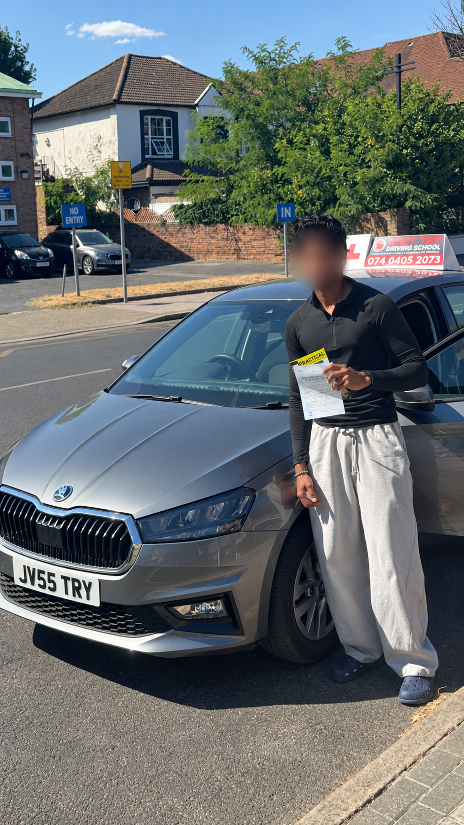 Learner holding their driving test pass certificate