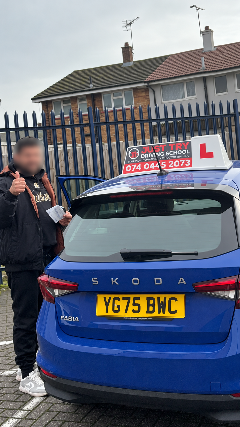 Learner holding their driving test pass certificate