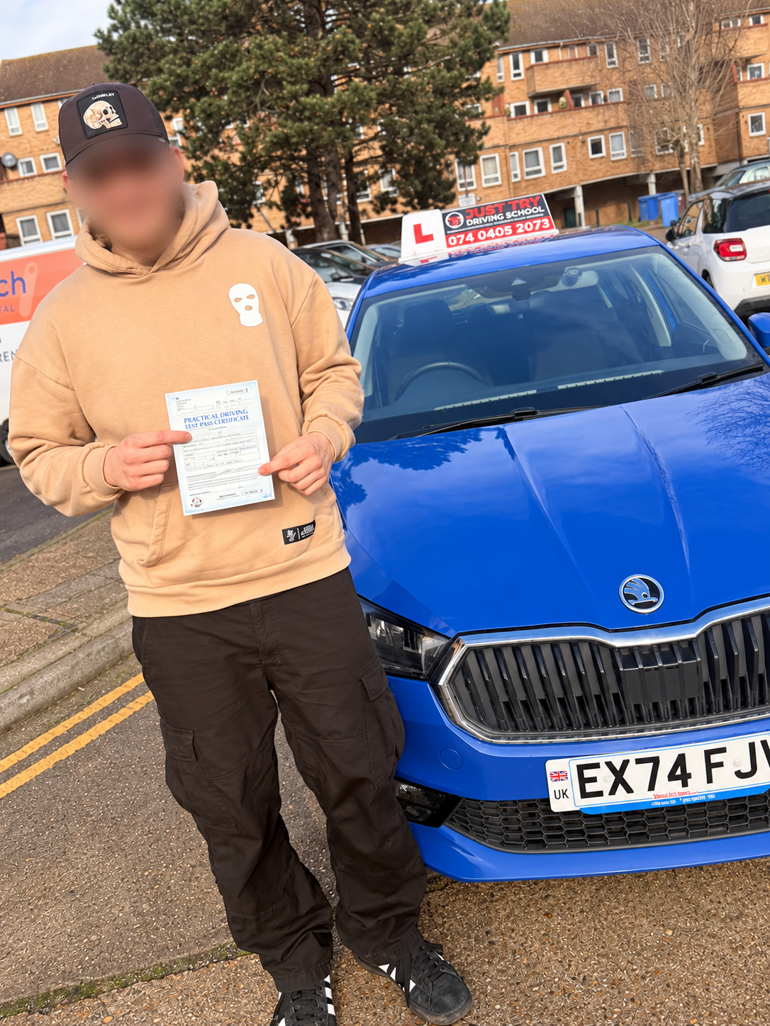 Learner holding their driving test pass certificate